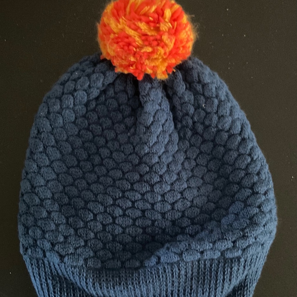 Verloop Blue knit hat with orange pom pom